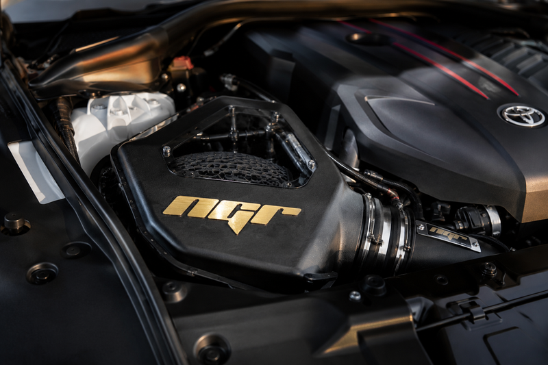 Load image into Gallery viewer, A close-up of a car engine bay featuring a black intake component with a gold N2F logo, set against a dark engine cover with a visible Toyota emblem.
