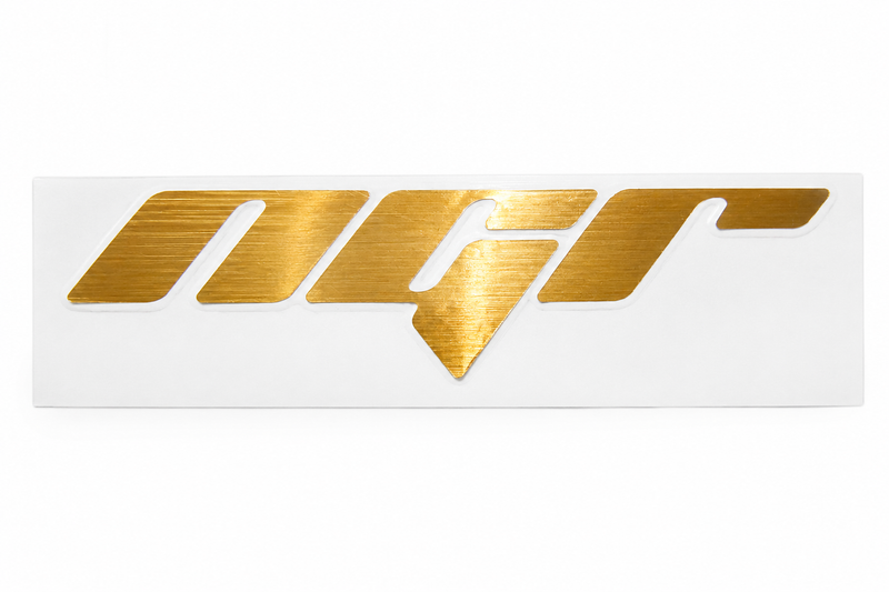 Load image into Gallery viewer, A metallic gold brushed-finish 'NGR' logo decal mounted on a white rectangular backing, shown against a plain white background.
